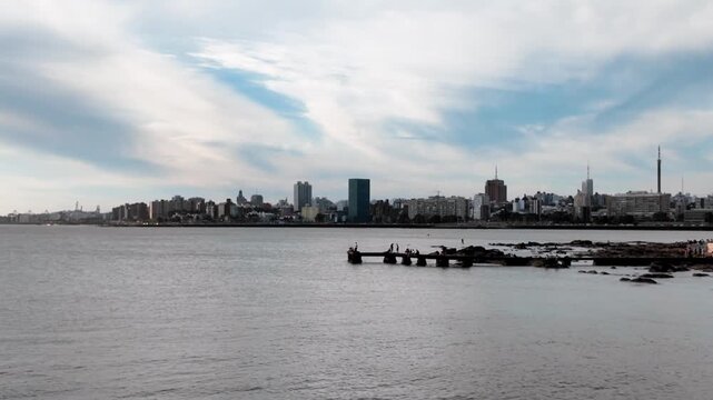 Pan across Playa Ramirez coastline at sunset, Parque Rodo, Montevideo, Uruguay