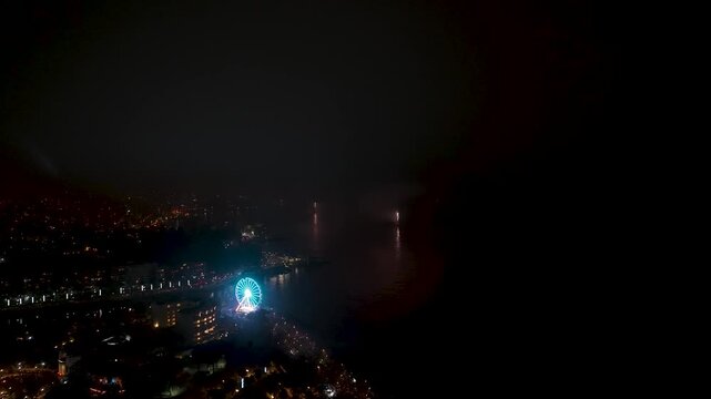 Aerial view of fireworks display over the ocean at dusk near a coastal city Valparaiso City