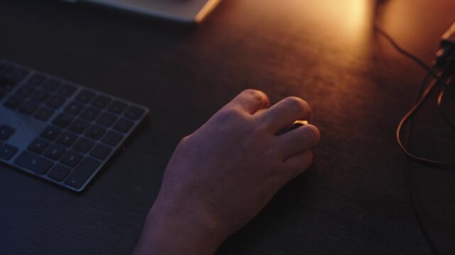 Close Up of Gamer Hand Using Computer Mouse on RGB Gaming Desk at Night