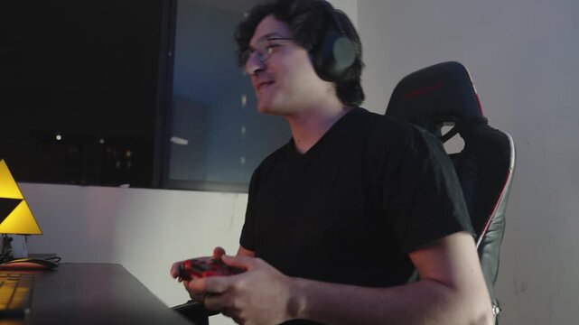 Young Male Gamer Playing Video Games in RGB Neon Gaming Room