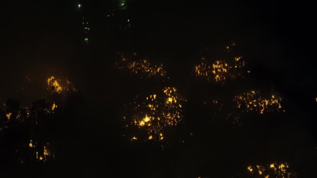Aerial Night View of Large Urban Fire with Heavy Smoke
