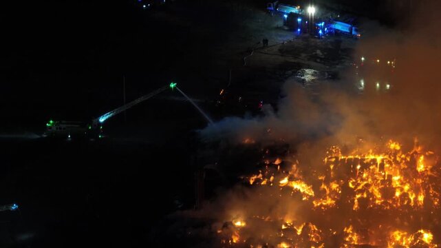 Aerial Night View of Large Urban Fire with Heavy Smoke