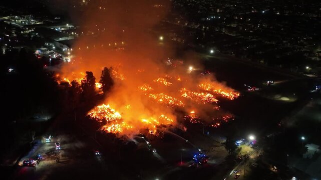 Aerial Night View of Large Urban Fire with Heavy Smoke