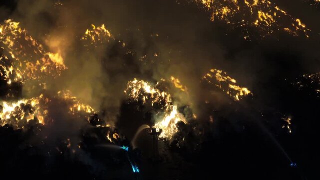 Aerial Night View of Large Urban Fire with Heavy Smoke