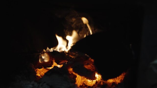 Close Up of Burning Firewood and Glowing Charcoal in Barbecue Grill