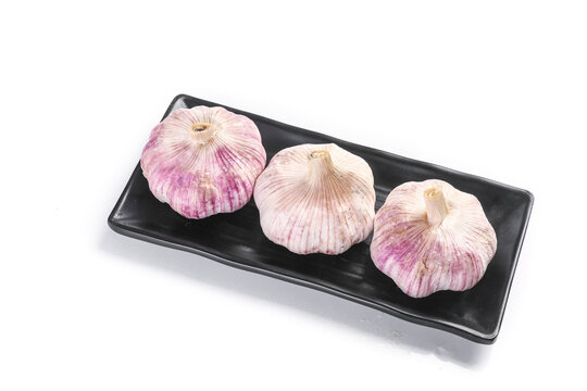 Purple Garlic Bulbs from Shandong Henan China on Black Plate - Fresh Farmer Produce with Violet Cloves