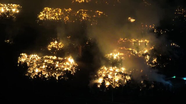 Aerial Night View of Large Urban Fire with Heavy Smoke