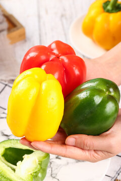Fresh Colorful Bell Peppers from Shandong China - Vibrant Red Yellow Green Vegetables in Hands
