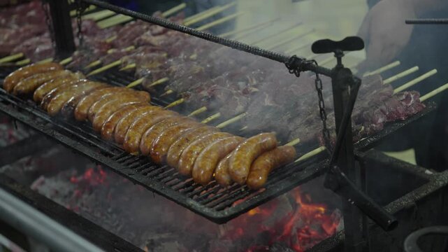 Grilled Meat Skewers and Sausages Cooking on Outdoor Barbecue Grill