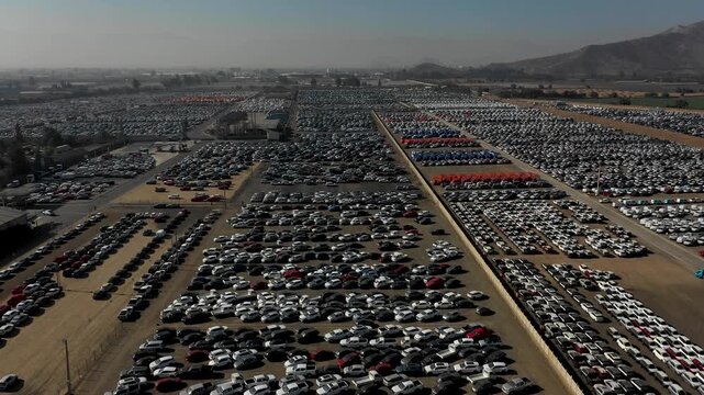 Aerial Drone View of Massive Vehicle Storage Lot with Thousands of Parked Cars