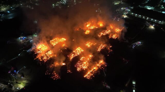 Aerial Night View of Large Urban Fire with Heavy Smoke