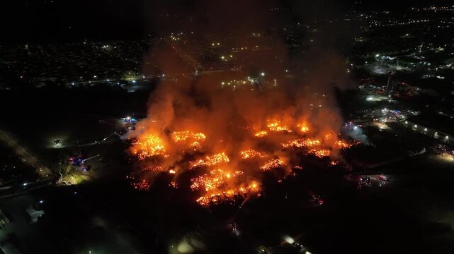 Aerial Night View of Large Urban Fire with Heavy Smoke