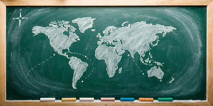 Green Chalkboard With Handwritten World Map Sketch And Travel Route In Light Wooden Frame With Colorful Chalk Sticks Geography Classroom Background With Copy Space