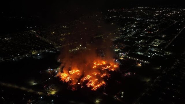 Aerial Night View of Large Urban Fire with Heavy Smoke