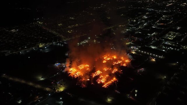 Aerial Night View of Large Urban Fire with Heavy Smoke