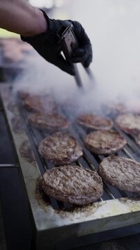 Grilled Meat Skewers and Sausages Cooking on Outdoor Barbecue Grill