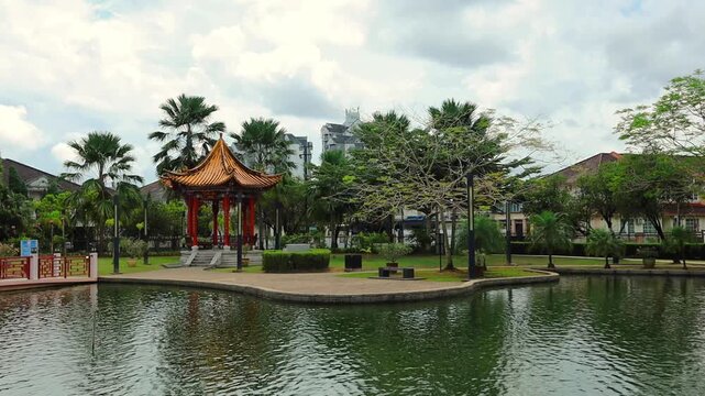Traditional Chinese-style temple building reflected in the water along the waterfront of Kuching, Sarawak, Malaysia