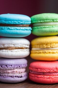 Vibrant close-up shot of stacked French macarons in assorted colors