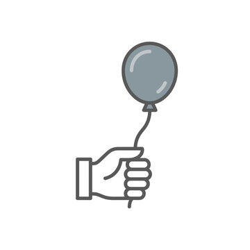 Hand holding balloon string against plain background