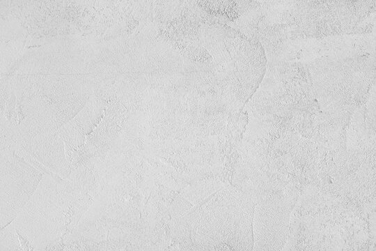 White stucco wall, uneven plaster surface, painted distressed concrete texture background. Abstract grunge backdrop, wallpaper for design, construction design element