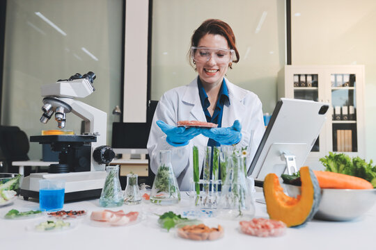 Scientists in lab coats work with plants in a modern lab, focusing on research and experimentation under bright, sterile conditions.