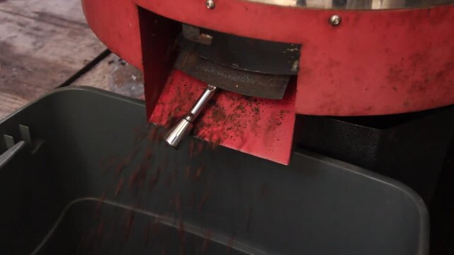 Coffee beans roasting inside an industrial roasting machine drum.