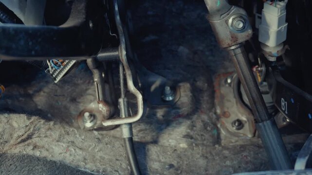 Car foot pedal linkage assembly and intermediate steering shaft column inside driver footwell