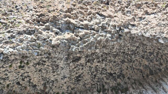 Textured rock surface with small stones
