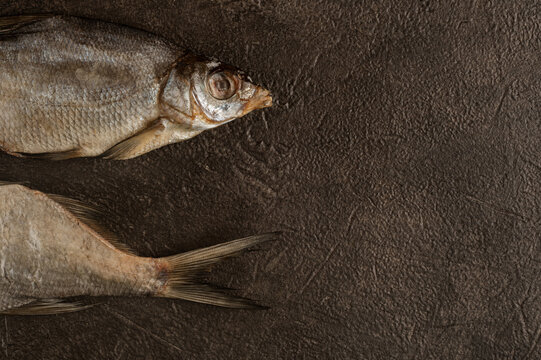 Dried Salted Fish on Dark Slate Surface
