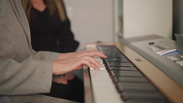 Studio rehearsal showcasing synchronized hands and collaborative practice. Two musicians practicing together under warm light while receiving coaching and sharing expressive performances