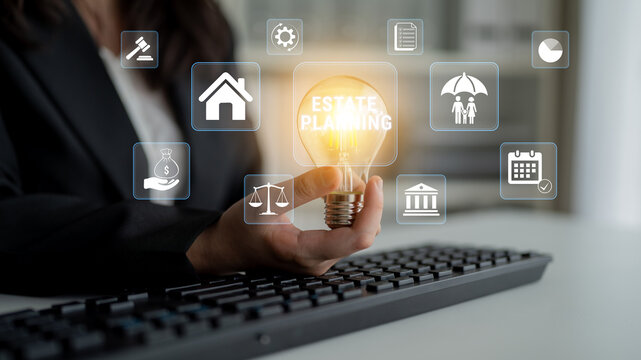 Business professional holding light bulb with digital icons, representing estate planning concepts and financial decisions, on keyboard in modern workspace. Glyphic.