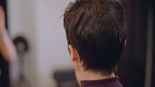 Shorthaired instructor facing student in studio, vocal coach listens intently, offering feedback during warmup session soft lighting and blurred pianist in background create intimate rehearsal