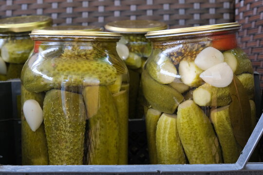Jars of homemade pickled cucumbers with garlic.