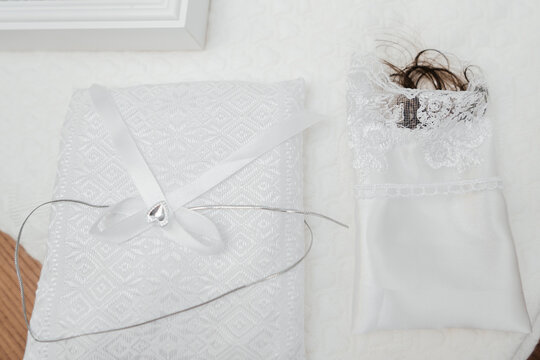 Christening cloth with a cut lock of baby hair