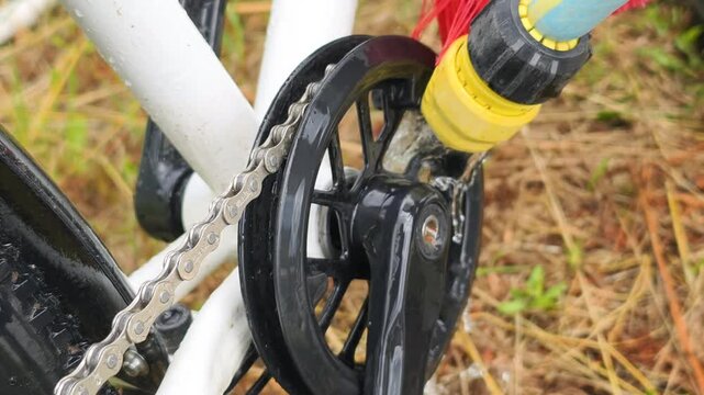 Lubrication prep starts with brush cleaning bicycle chain, removing dirt and water splashes. Lubrication prep ensures smooth gears, preparing drivetrain for proper maintenance and performance.