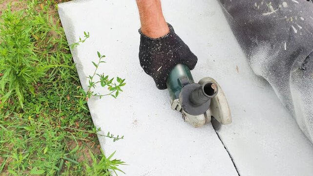 Sheet cutting uses angle grinder blade, slicing through gray material with steady precision. Sheet cutting requires protective gloves and safety focus, ensuring professional construction results.