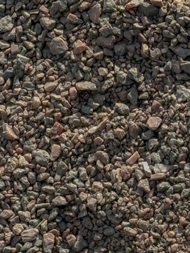 Crushed granite stone texture background, rough gravel pebbles pattern for construction and landscaping