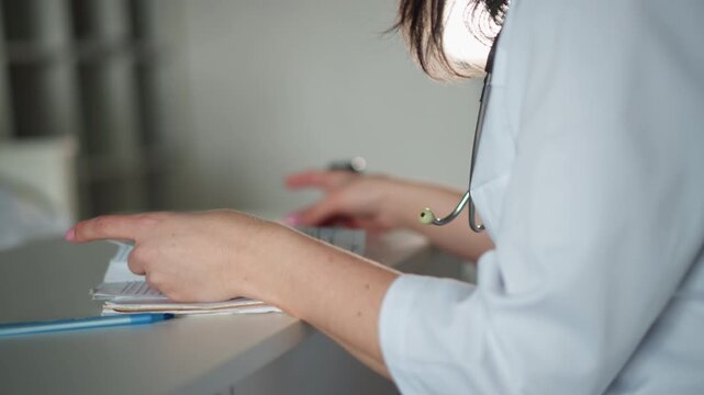Doctor reviewing files. Medical professional examining patient records. Healthcare worker carefully flipping through charts while documenting essential patient data in office environment