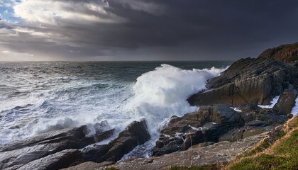 Fototapeta premium A Rocky Coastline With A Large Wave Crashing Against The Shore Under A Stormy Sky