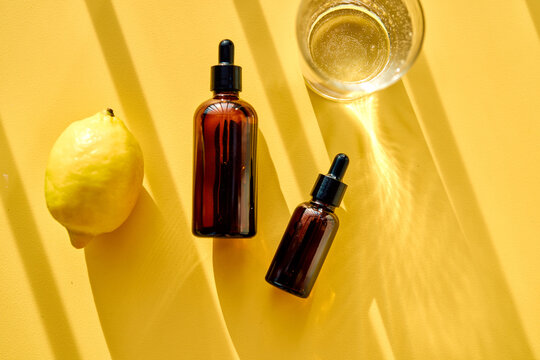 Vitamin c serum dropper bottles with lemon promoting skincare