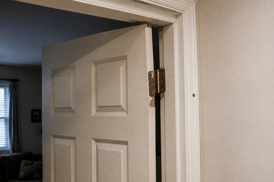 Interior door with damaged hinge causing sagging and improper alignment
