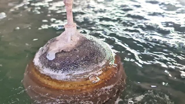 Close up of a water tank float ball valve regulating liquid level and water flow