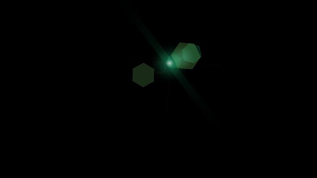 Green light lens flare effect against black background