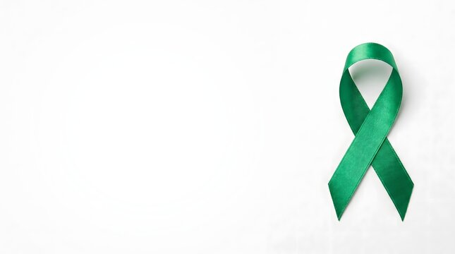 Green awareness ribbon isolated on white background with copy space, World Mental Health Day and organ donation concept
