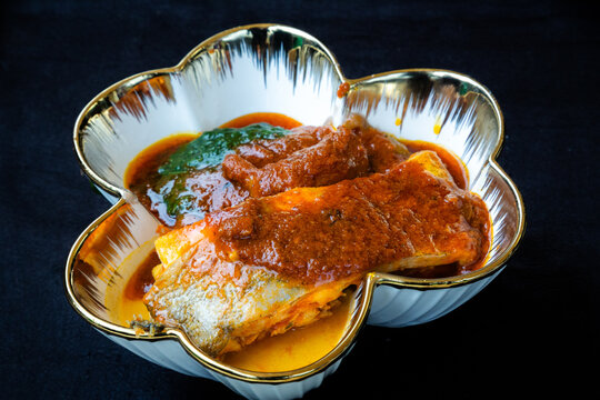 A serving of fish accompanied by ewedu and gbegiri soups, traditional Yoruba dishes commonly served with Nigerian swallow meals