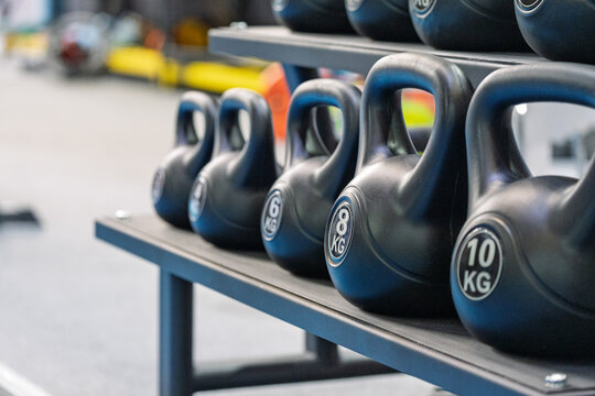 different weight kettlebells placed on gym equipment rack