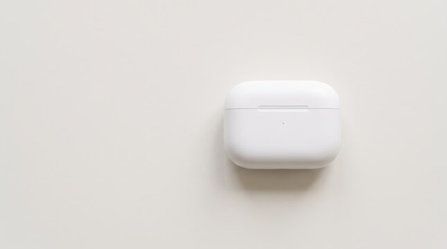 Top view of white wireless earbuds charging case on light, minimalist tech gadget design for modern lifestyle, clean aesthetic product photography suitable for commercial use