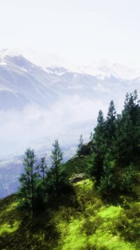 Rolling hills embrace the majestic mountains, while vibrant green trees dance in the gentle breeze under a clear blue sky. Natures beauty shines in this tranquil setting, inviting adventure.