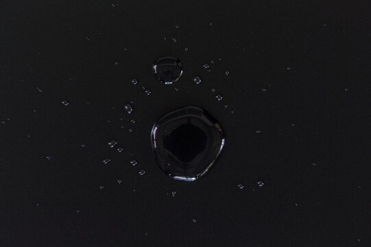 Single water drop on black background macro