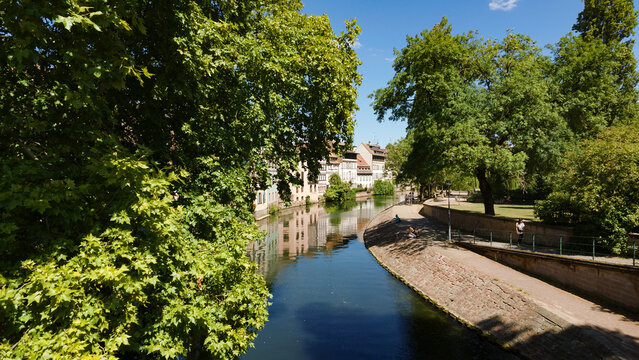 Strasbourg cityscape with buildings reflecting in the Ill River on a sunny day